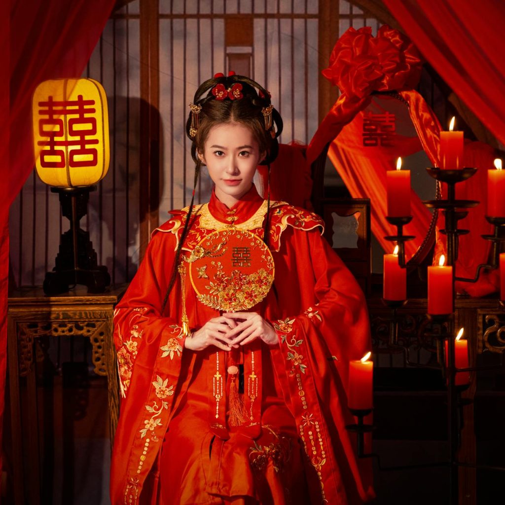 woman posing among traditional decorations