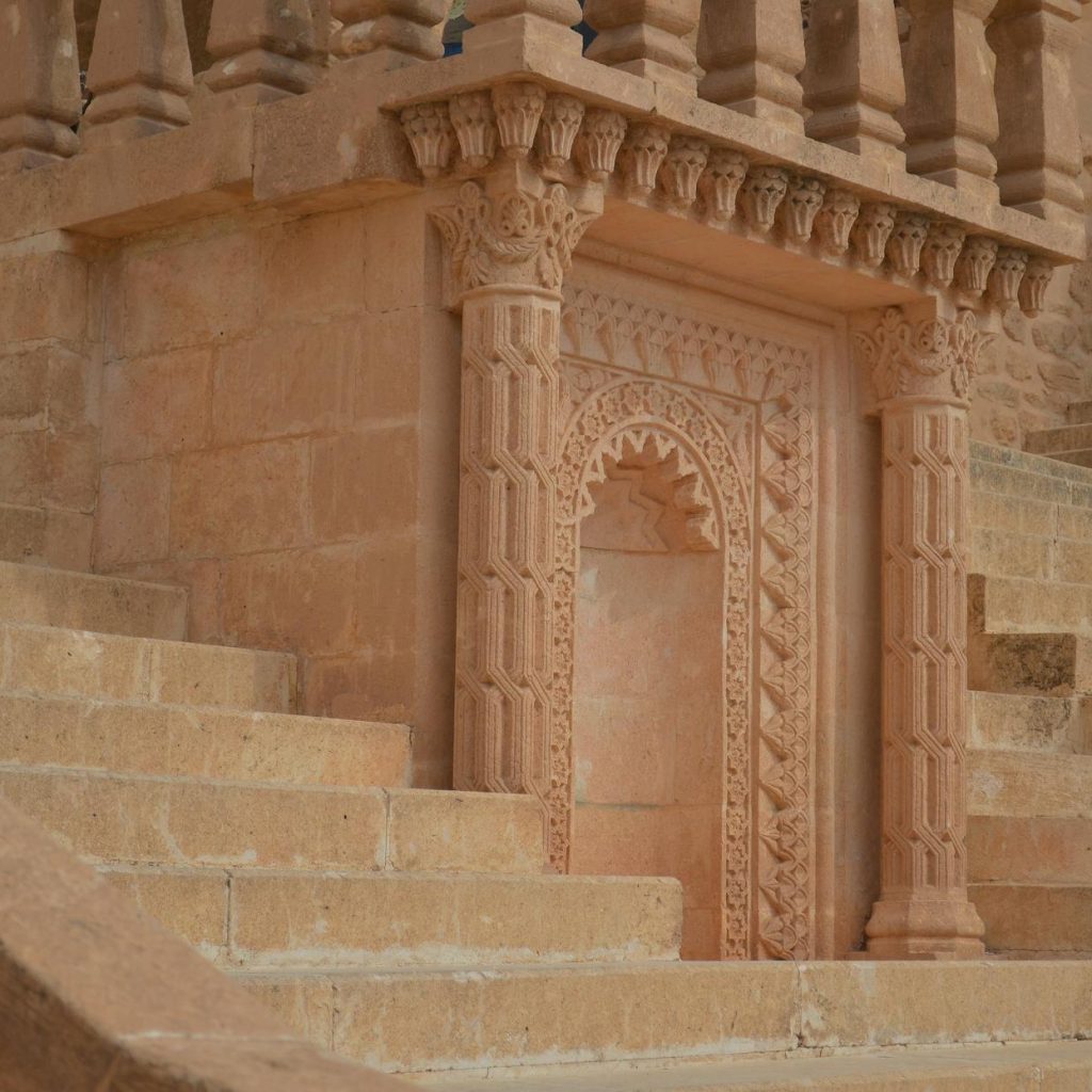 close up of stairs and columns of a sandstone temple