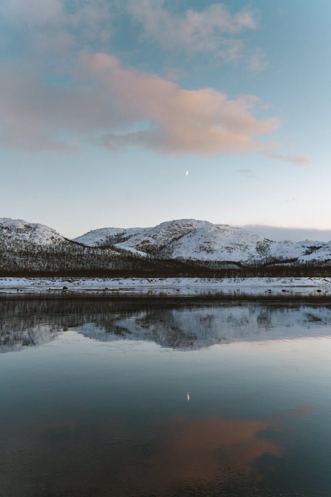 a lake near the snow covered mountain